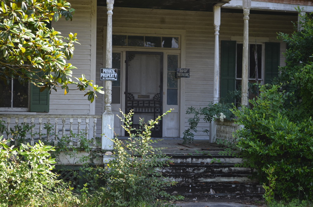 Front porch of abandoned house in small South Carolina town by congaree