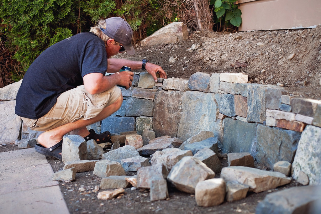 My hubby working on his latest rock wall by kiwichick
