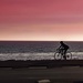 Biker along Malibu Beach at Sunset by jaybutterfield