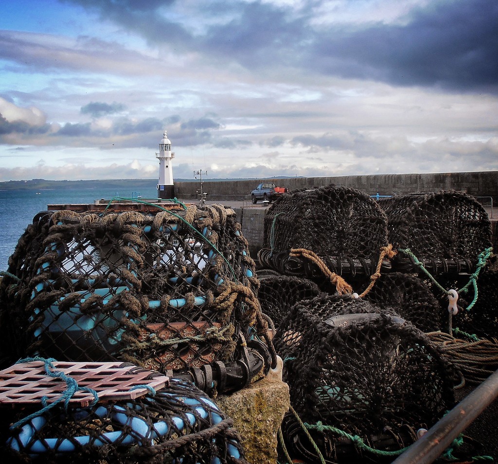 Lobster pot and lighthouse by swillinbillyflynn
