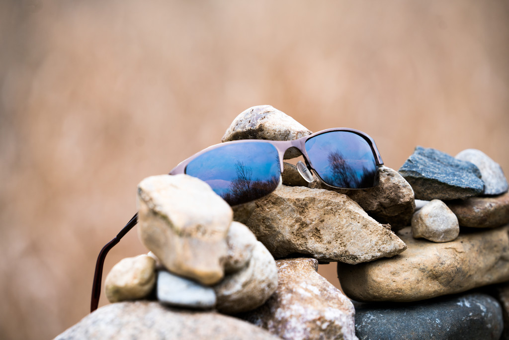 Sunglasses on a rock pile by rminer