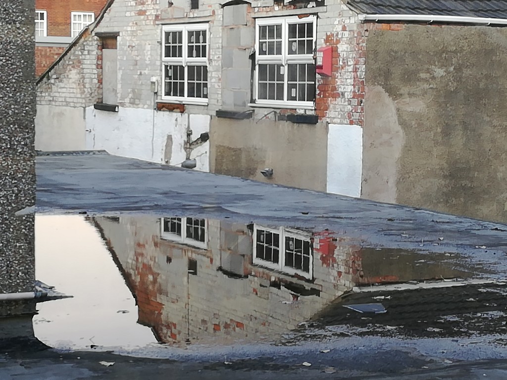 Flat roof puddle reflection by plainjaneandnononsense