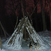 Tipi structure in the moonlight woods.  by hellie