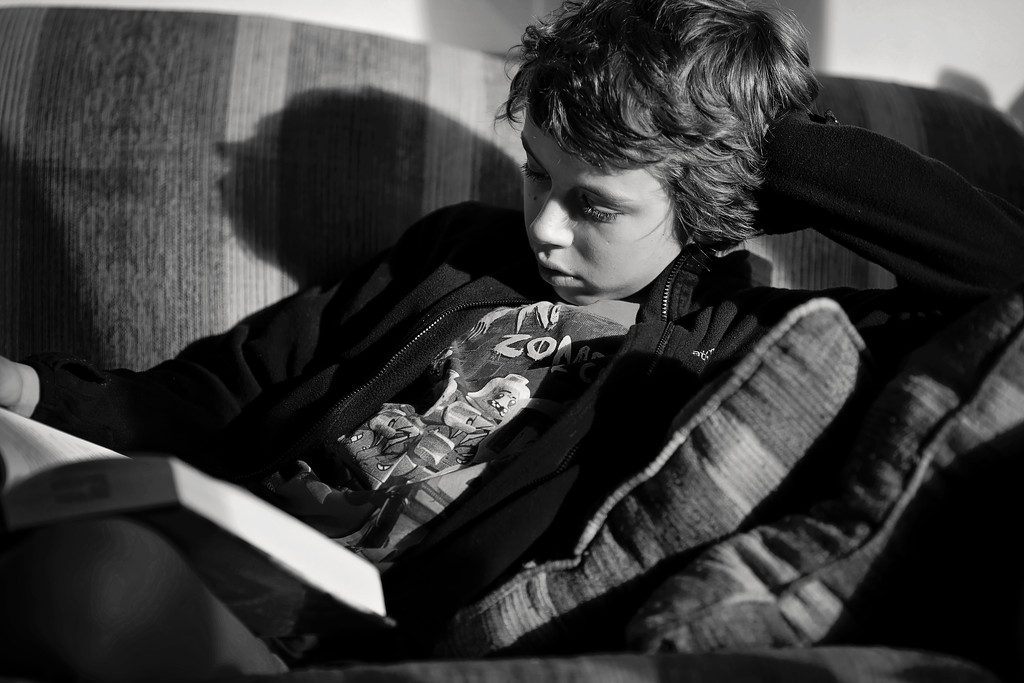 Reading on the couch by kiwichick
