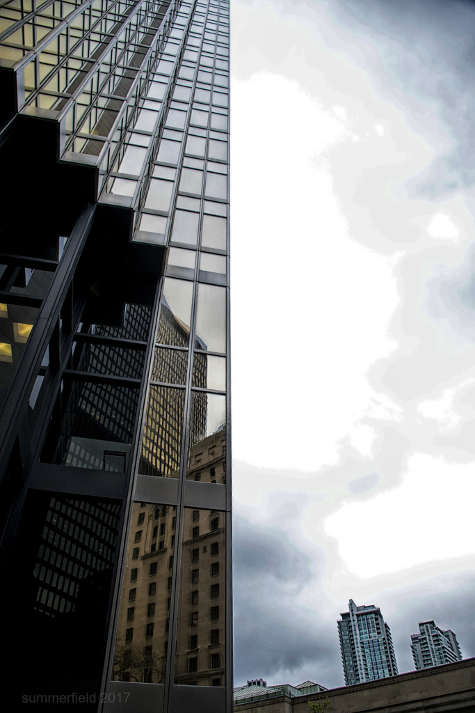 glass and steel and cloudy sky by summerfield