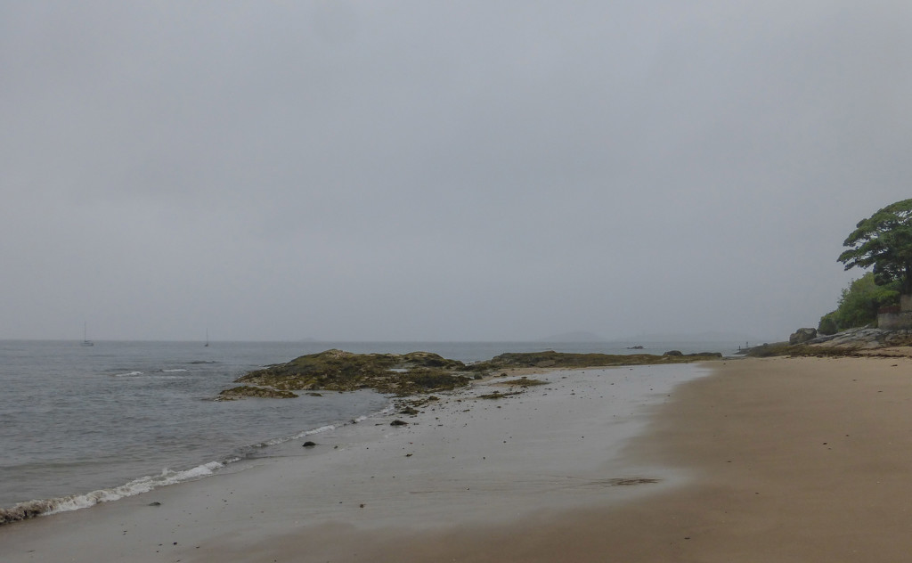 Empty beach in the rain by frequentframes