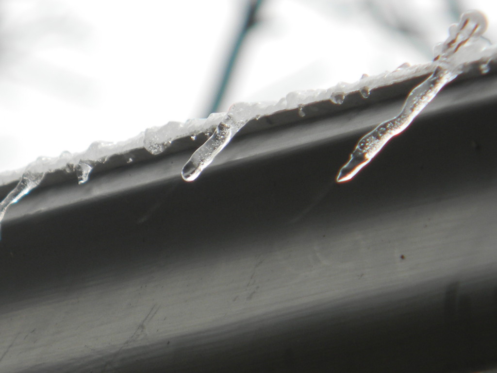 Close-up of Icicles on Roof by sfeldphotos