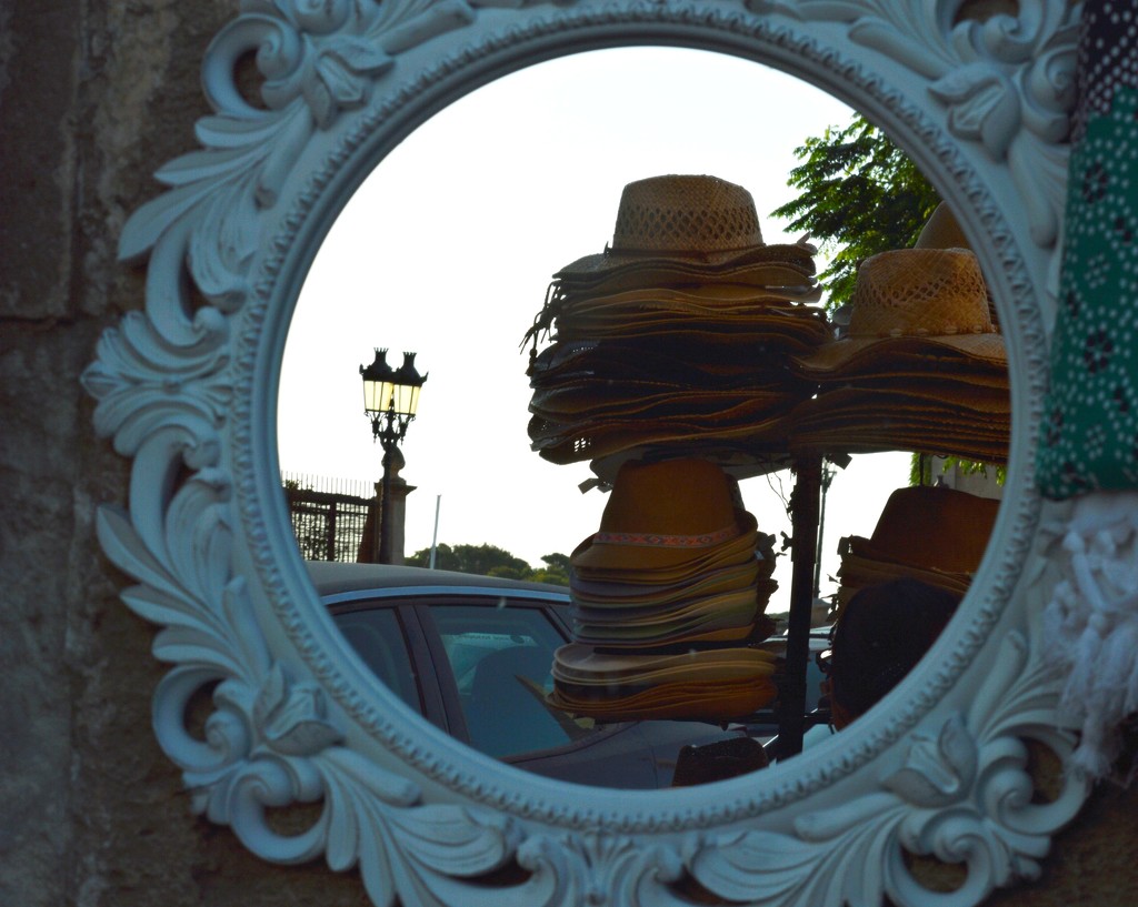 hats in a mirror by caterina