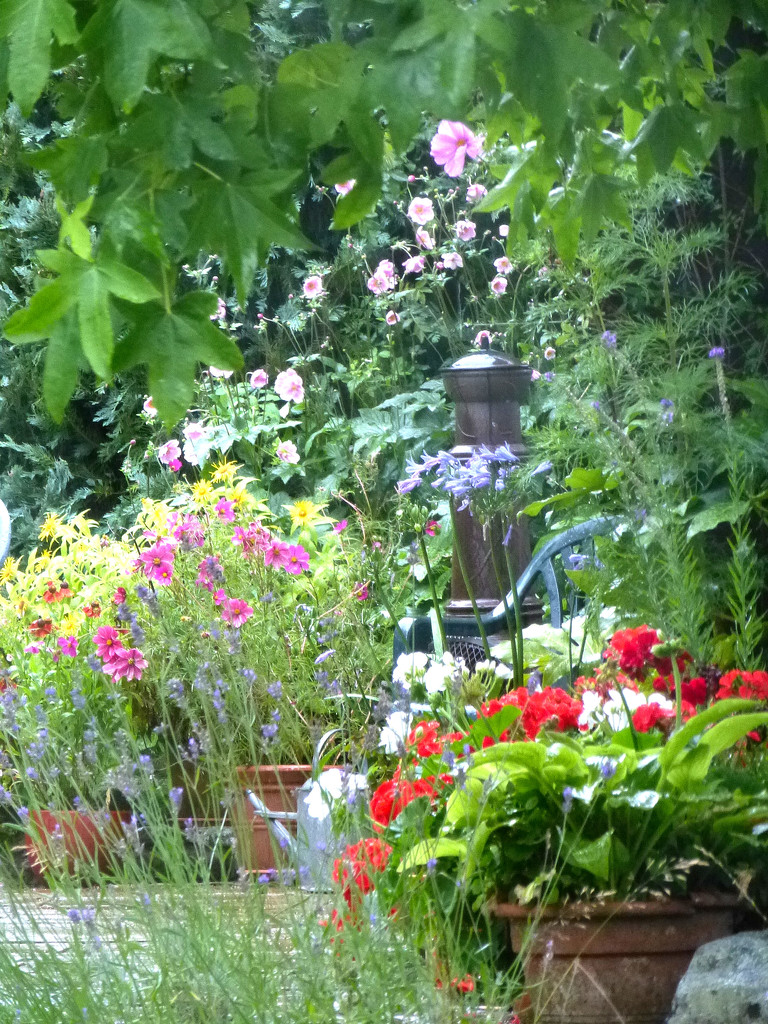 Chimenea surrounded by the flowers in the garden.. by snowy