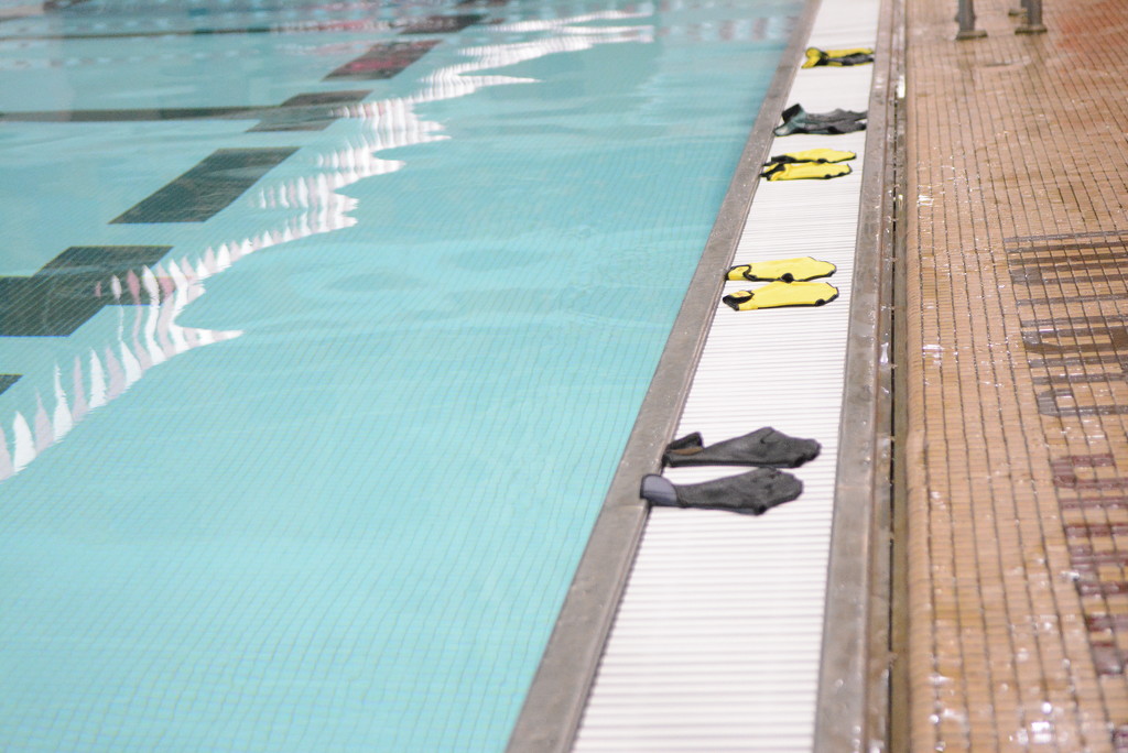 Gloves Lined Up by Swimming Pool by sfeldphotos