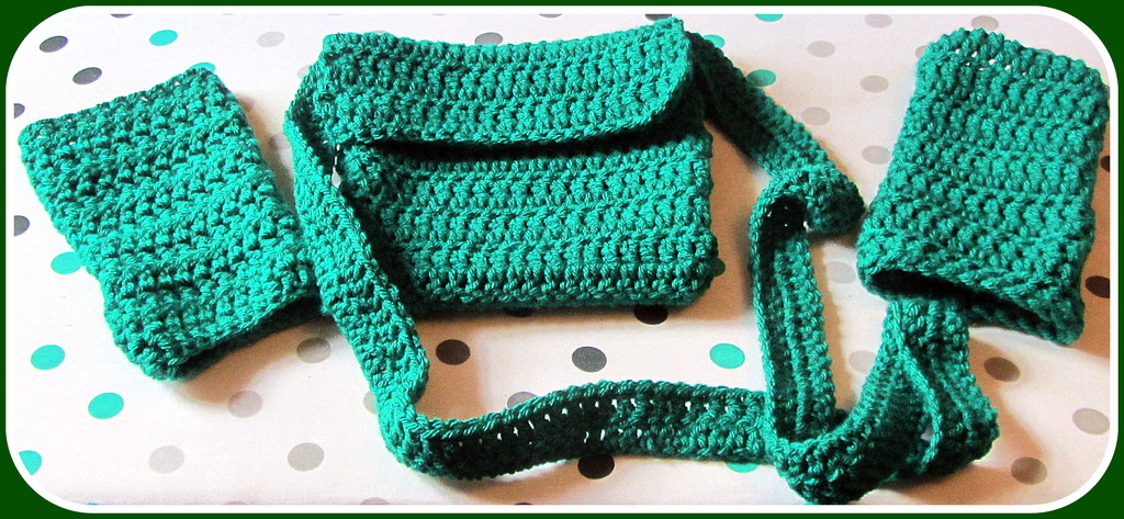 A crocheted green acrylic bag and a pair of handwarmers. by grace55