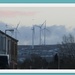 Wind turbines and snow on the hills and roofs. by grace55