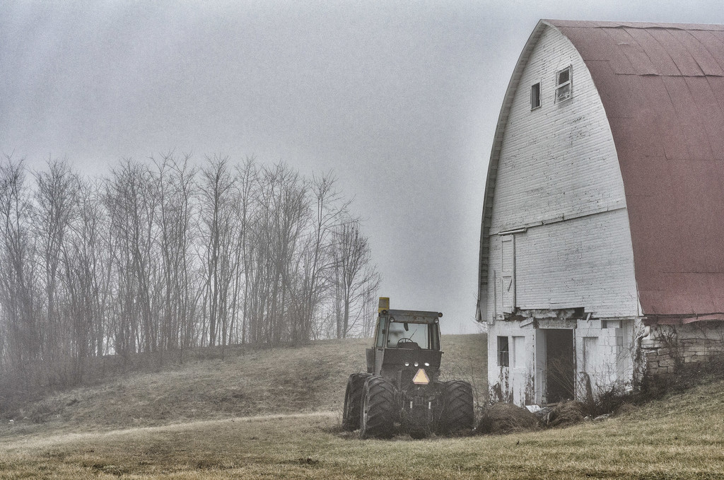 Tractor waits for work at Braun farm by ggshearron