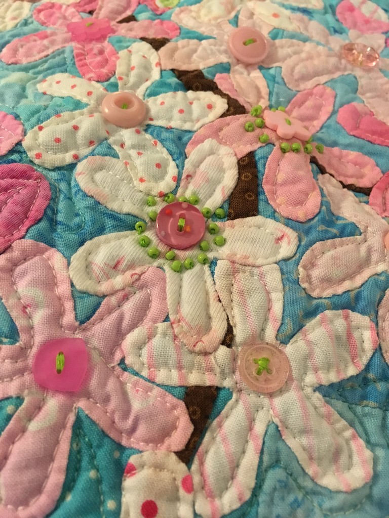 sewing beads on my cherry blossom quilt  by wiesnerbeth