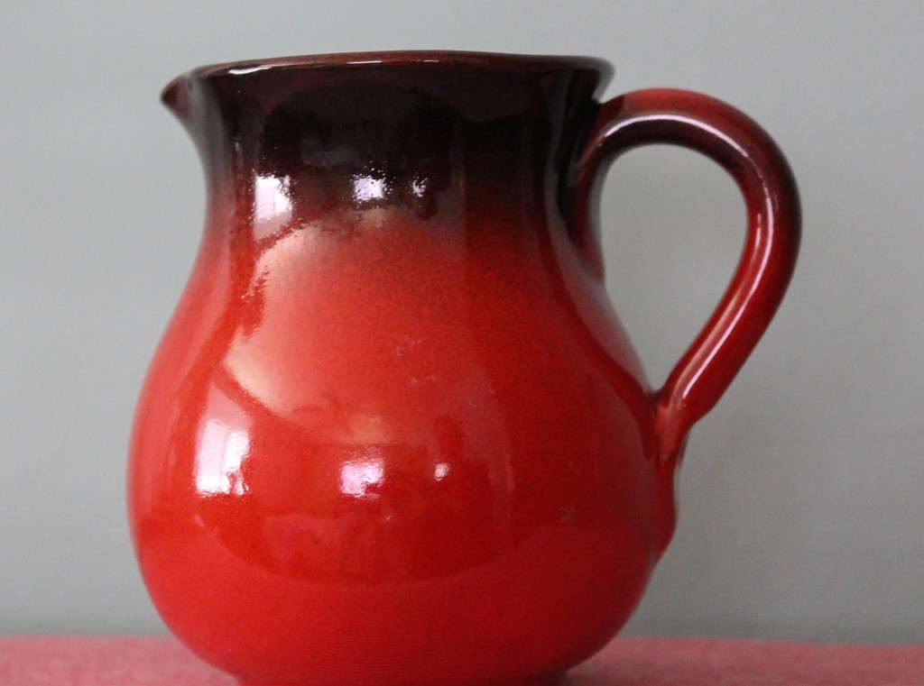 Red pitcher by mittens