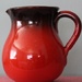 Red pitcher by mittens