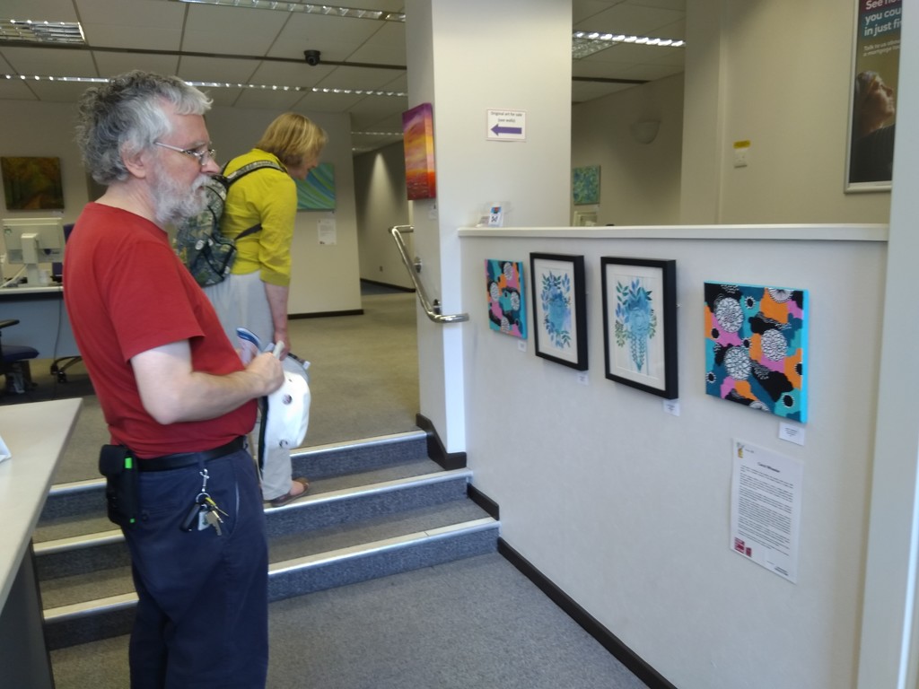 Laurence looking at my paintings on the Rugby festival of culture art trail by cpw