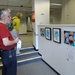 Laurence looking at my paintings on the Rugby festival of culture art trail by cpw
