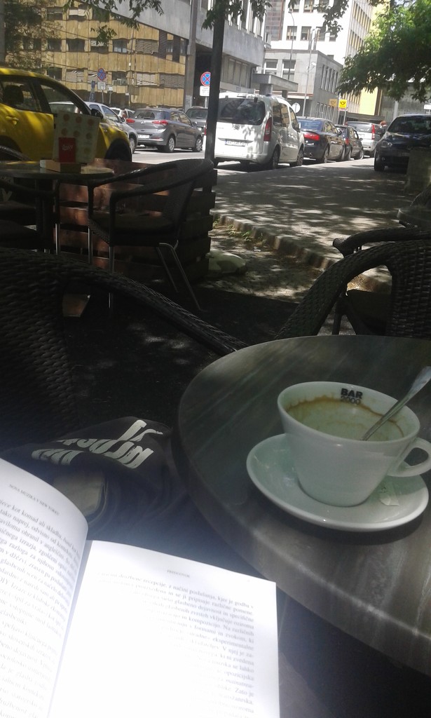 Reading in an outdoor cafe by zardz
