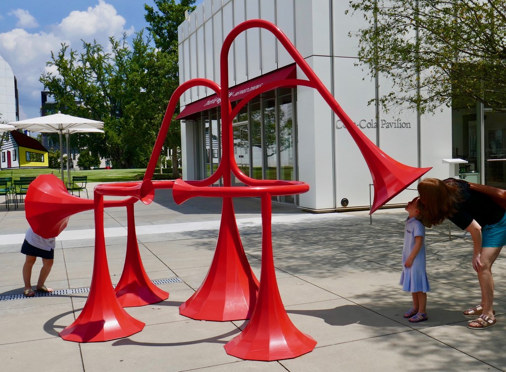 Family enjoying  one of the communication sculptures on the High Museum Plaza by swagman