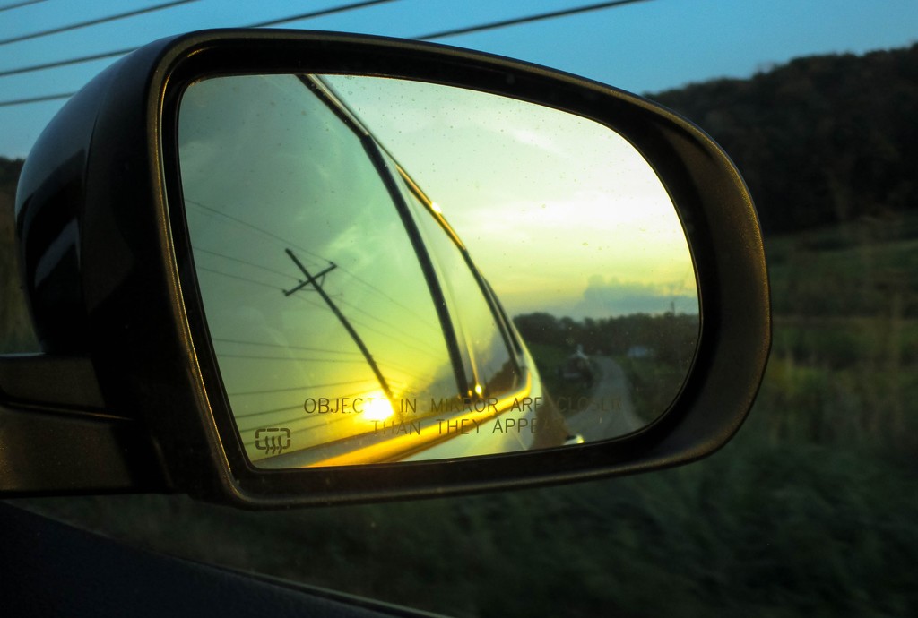 Side view mirror at sunset by mittens