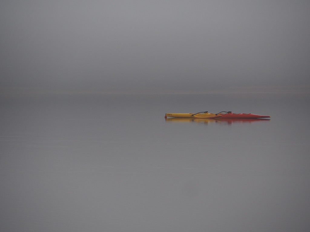 2 kayaks greet a grey day. by s4sayer