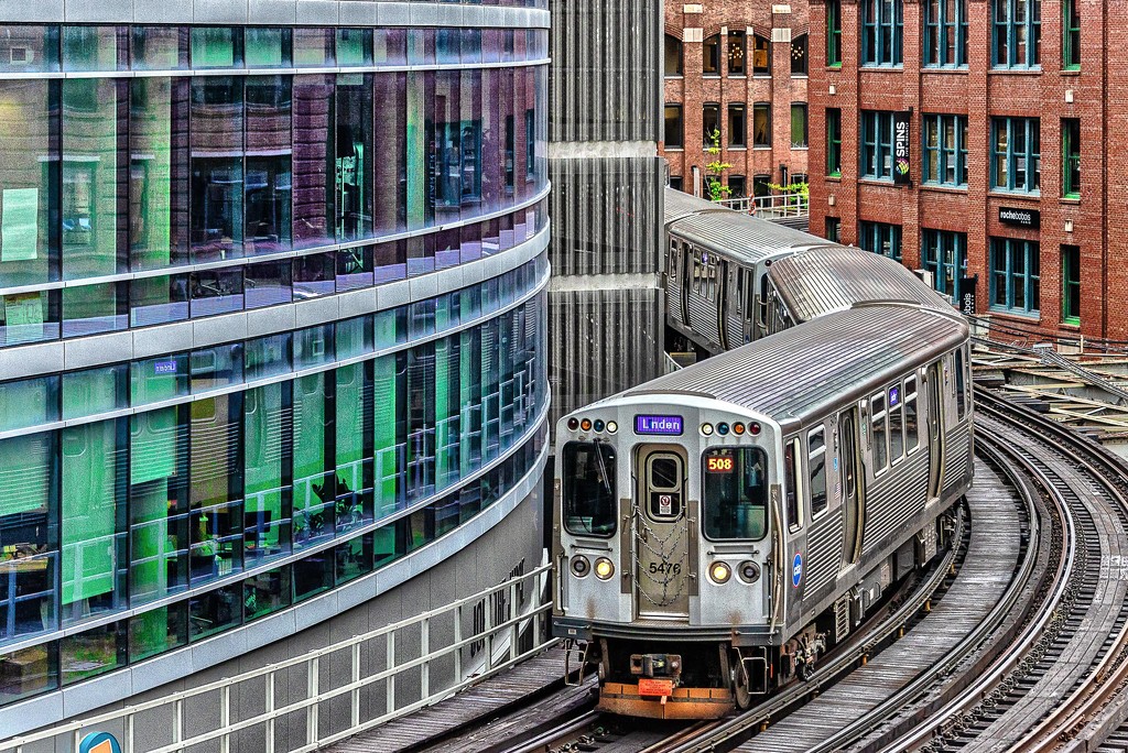 Colorful Buildings Hug the Gray Train by taffy