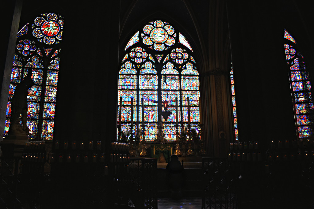 Praying Inside Notre Dame by alophoto