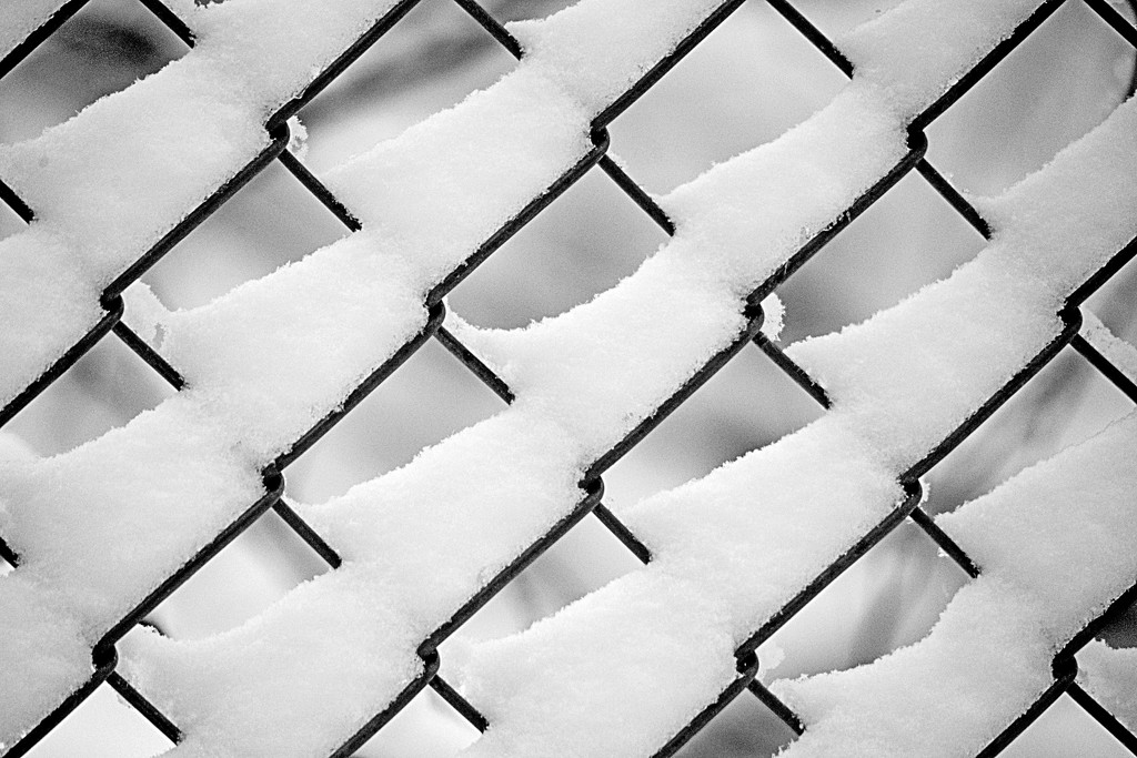 Chain link fence with snow drifts! by fayefaye