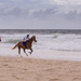 racing horses on the beach by ulla