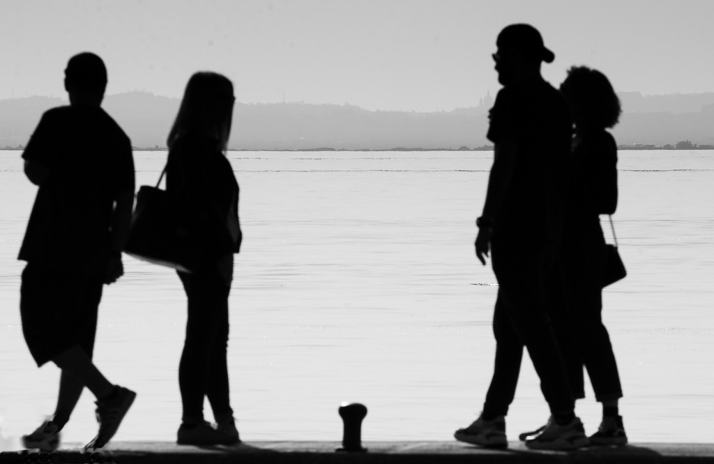Silhouettes at the lake shore by caterina