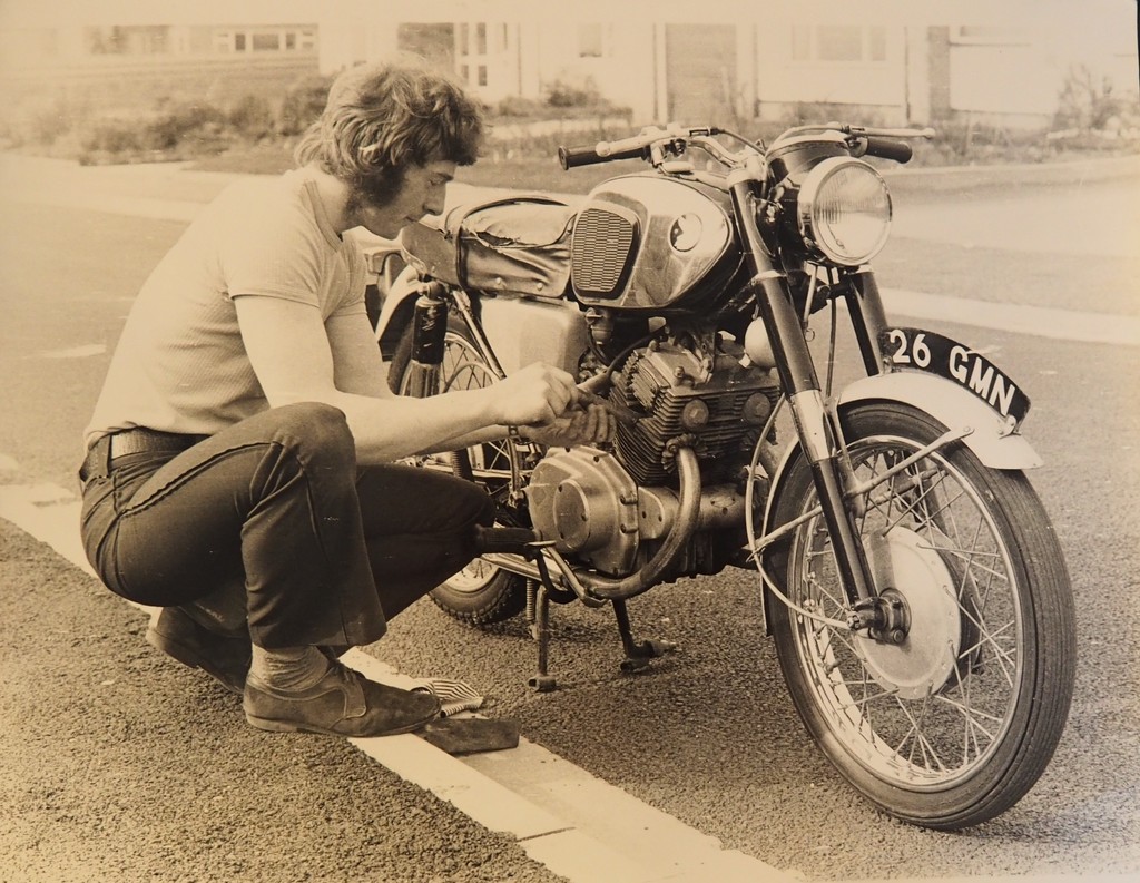 Treasure, 24.   Michael, fettling his motor bike, 1972? by s4sayer