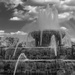Clouds and an Airplane Over Buckingham Fountain  by taffy