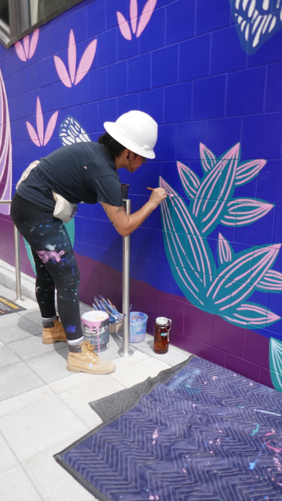 Woman muralist at working in Midtown Atlanta by swagman