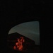 Woodpile as seen in side view mirror lit by brake lights by mcsiegle