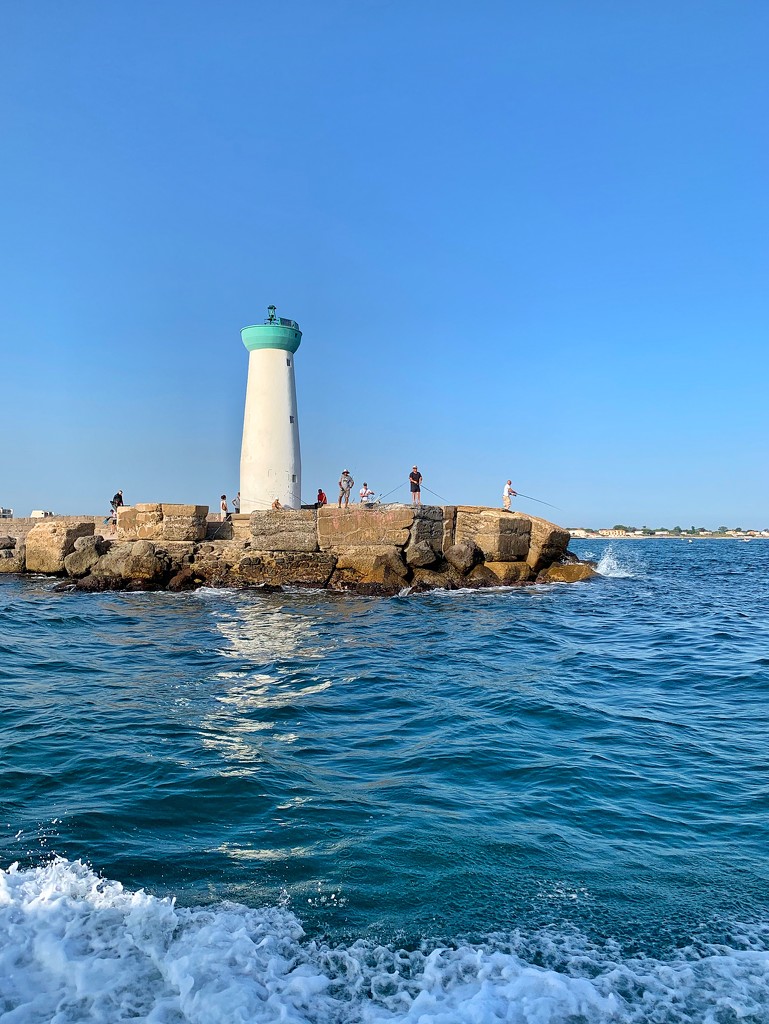 Fishermen at the lighthouse.  by cocobella