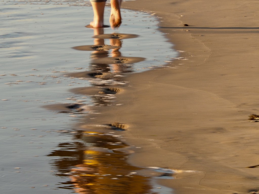 Footsteps and reflections in the sand  by jacqbb