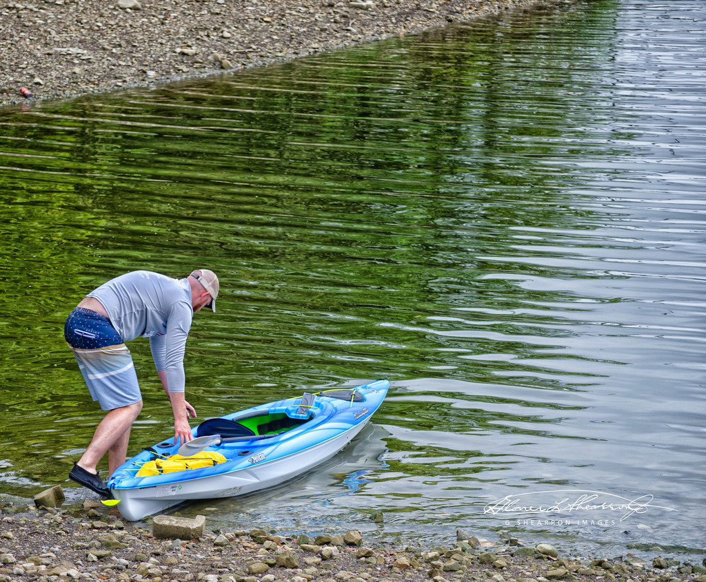 Man Readies His Canoe for Boarding by ggshearron