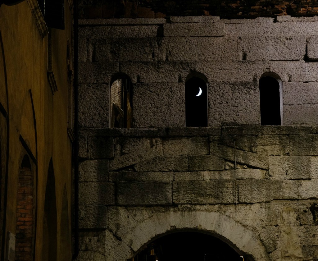 The moon shines through the Roman door by caterina