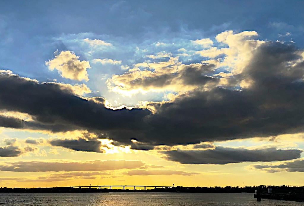 Dramatic sunset and clouds over the Ashley River at The Battery in Cgarkeston. by congaree