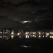 Moon peeking through clouds at Colonial Lake by congaree