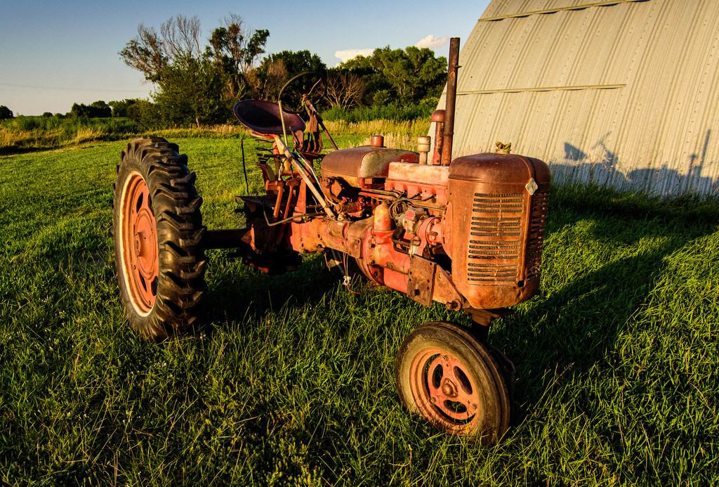 Old Tractor at Sunset by jeffjones