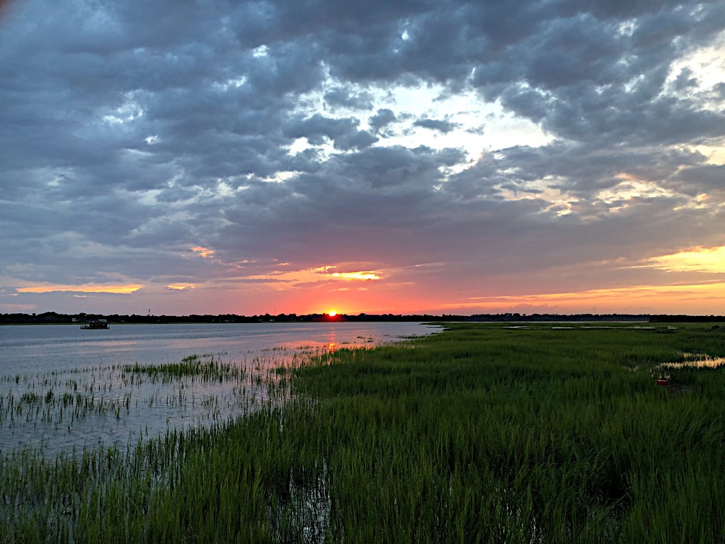 Sunset over the marsh at high tide by congaree