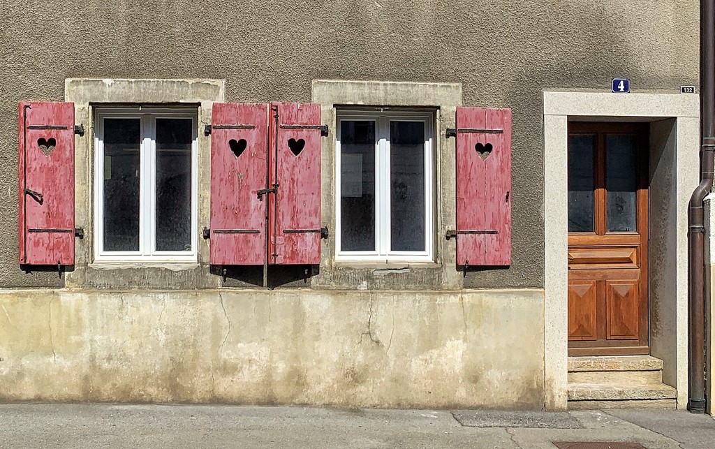 Hearts on red shutters.  by cocobella