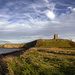 Dunstanburgh castle at golden hour by fueast