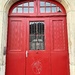 Three red hearts on a red door.  by cocobella