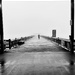 Man running on the pier.  by clayt