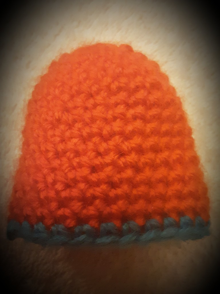 A little orange crocheted hat. by grace55