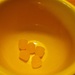 Yellow gumdrops in a large yellow mug by mittens