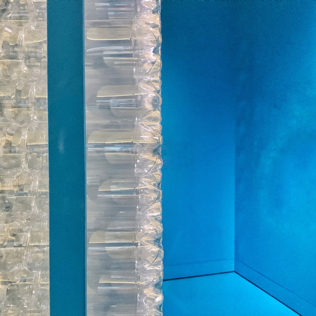 Half plastic bottles / half blue wall.  by cocobella